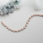 a bridal bracelet with pearls on a white background