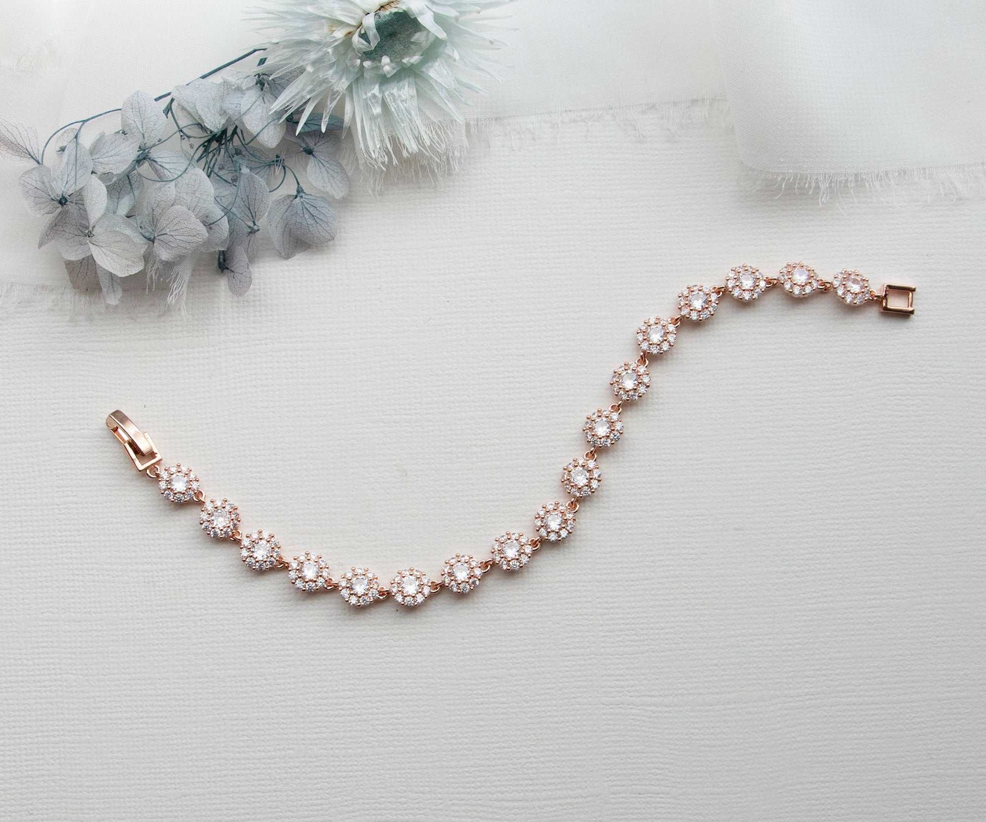 a bridal bracelet with pearls on a white background