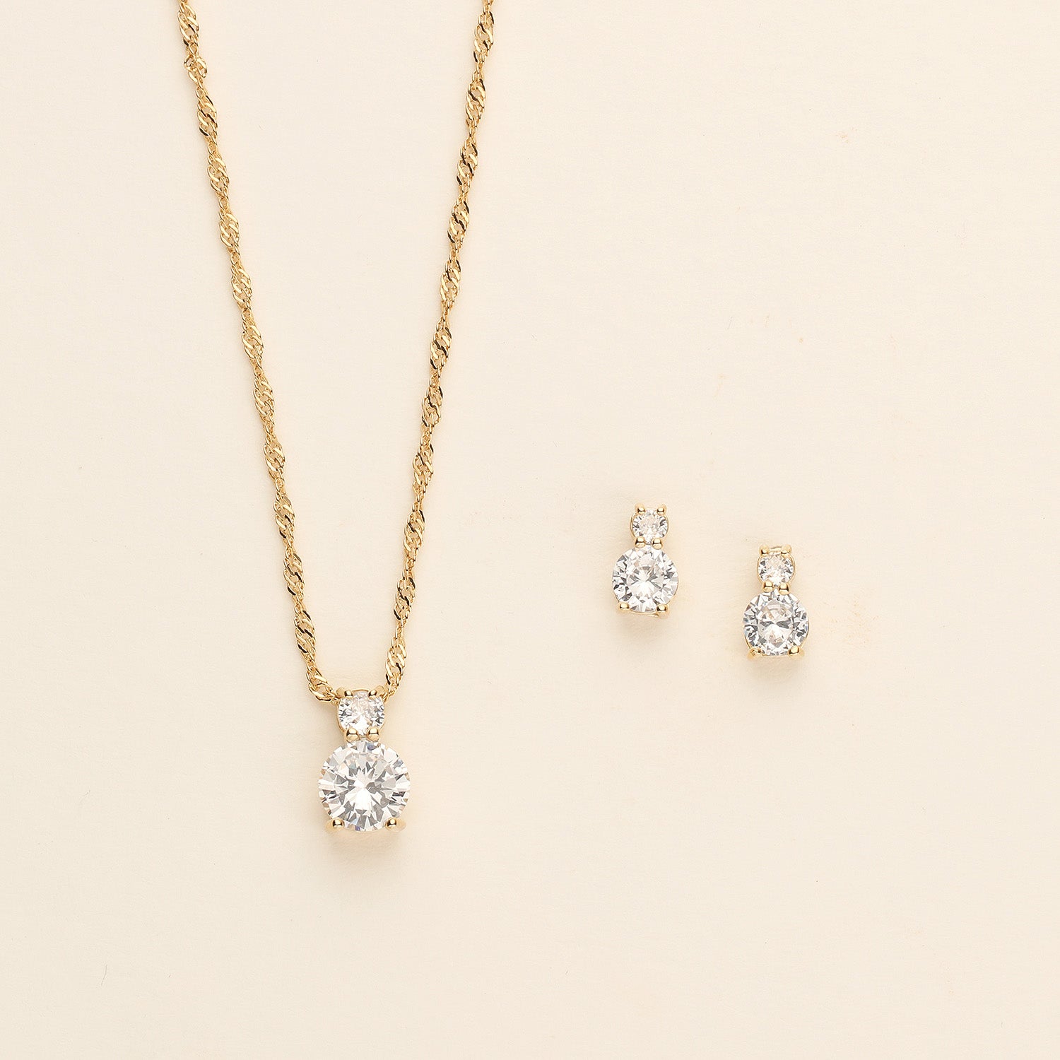 a necklace and earring set with a diamond