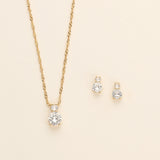 a necklace and earring set with a diamond