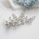 a close up of a brooch on a white cloth