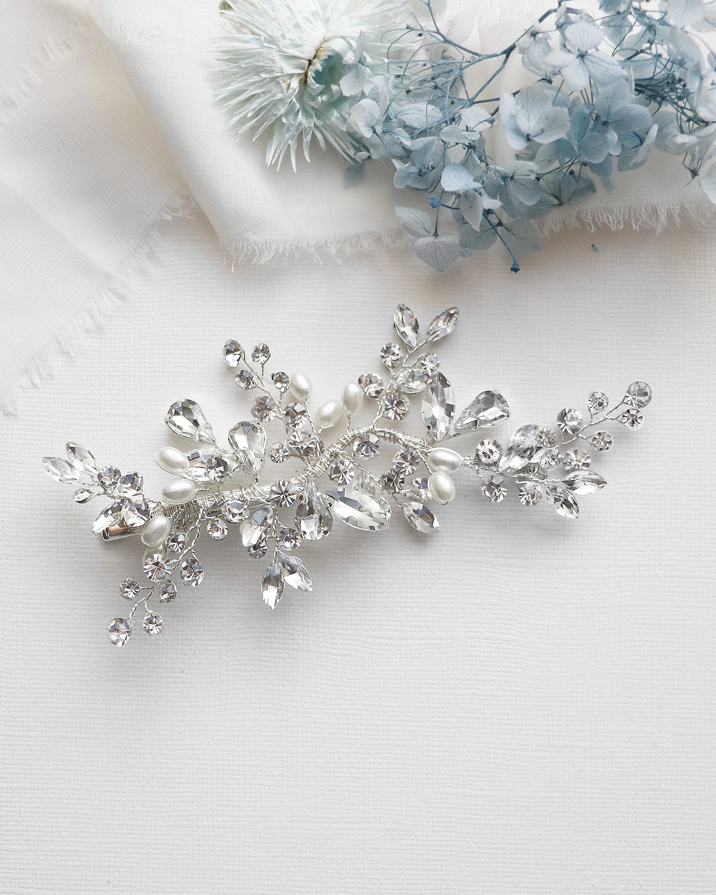 a close up of a brooch on a white cloth