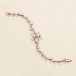 a close up of a bracelet on a white surface