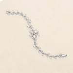 a diamond and pearl bracelet on a white background