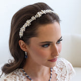 a woman wearing a headband made of pearls