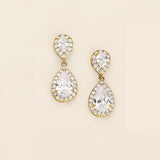 a pair of diamond earrings on a white background