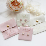 a set of four pink and white jewelry boxes