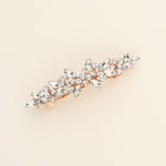 a gold brooch with a bunch of crystal stones