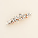 a gold brooch with a bunch of crystal stones