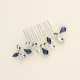 a close up of a hair comb with blue and clear stones