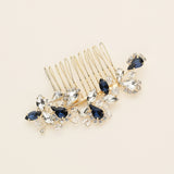 a hair comb with blue and clear stones on it