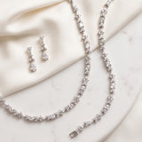 a collection of elegant jewelry pieces, including a necklace, earrings, and a bracelet, all adorned with sparkling diamonds.