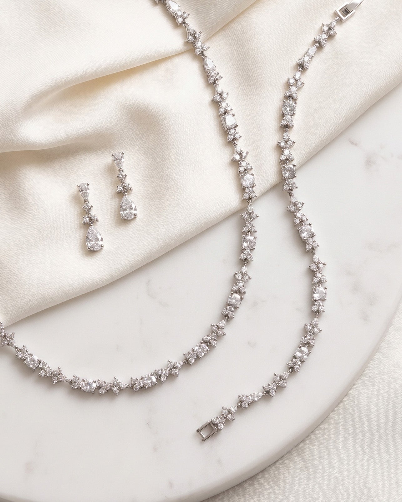 a collection of elegant jewelry pieces, including a necklace, earrings, and a bracelet, all adorned with sparkling diamonds.
