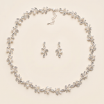A necklace and earrings set with a delicate leaf-like design and sparkling crystal elements.