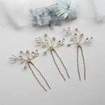 three different types of hair pins on a white surface