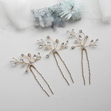 three different types of hair pins on a white surface