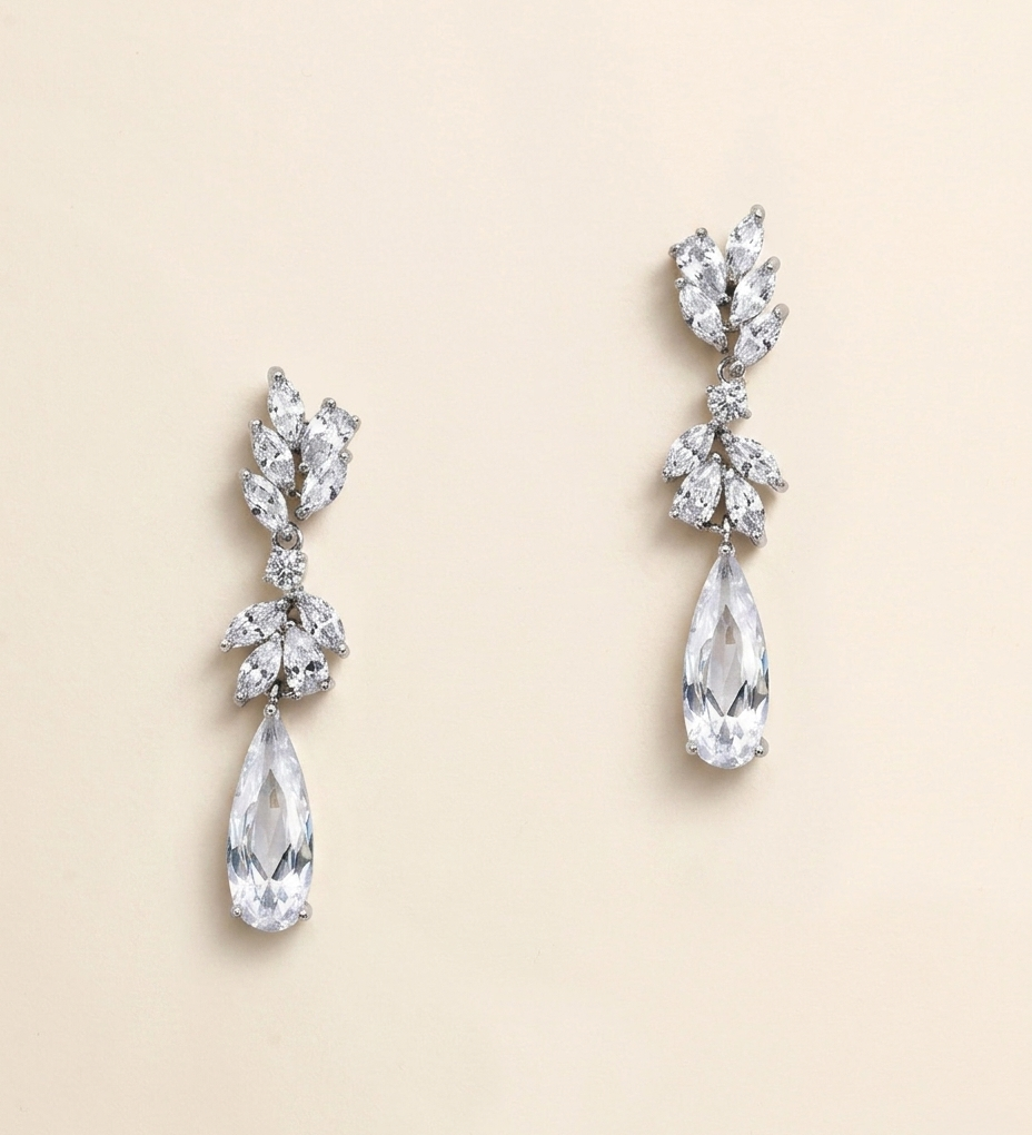 A pair of elegant earrings with large, clear gemstones hanging from the bottom.