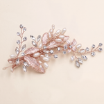 A decorative hair clip adorned with pearls, crystals, and leaves.