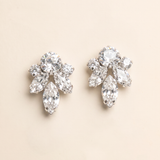 A pair of elegant diamond earrings with multiple large, clear gemstones set in a floral design.