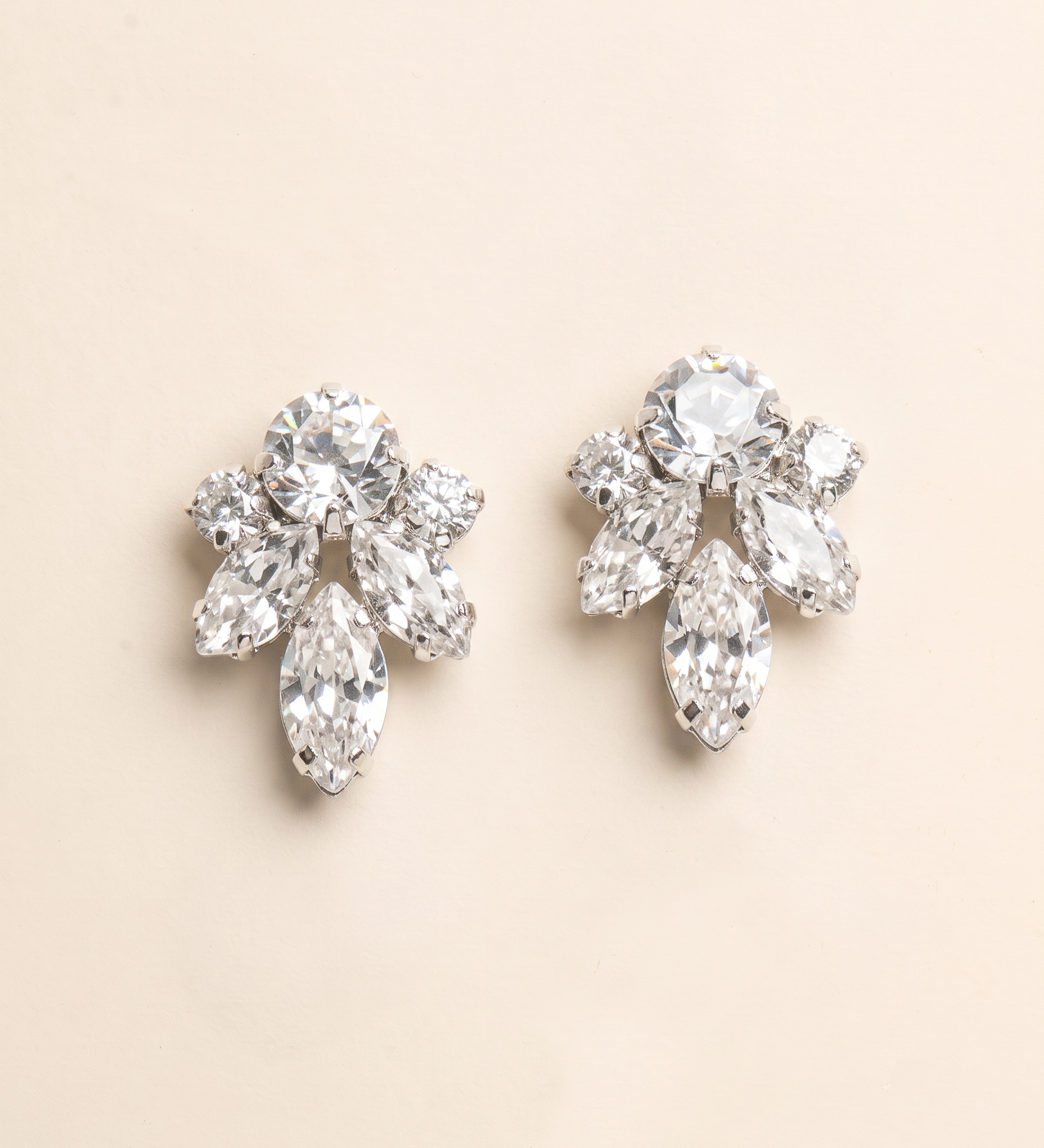 A pair of elegant diamond earrings with multiple large, clear gemstones set in a floral design.