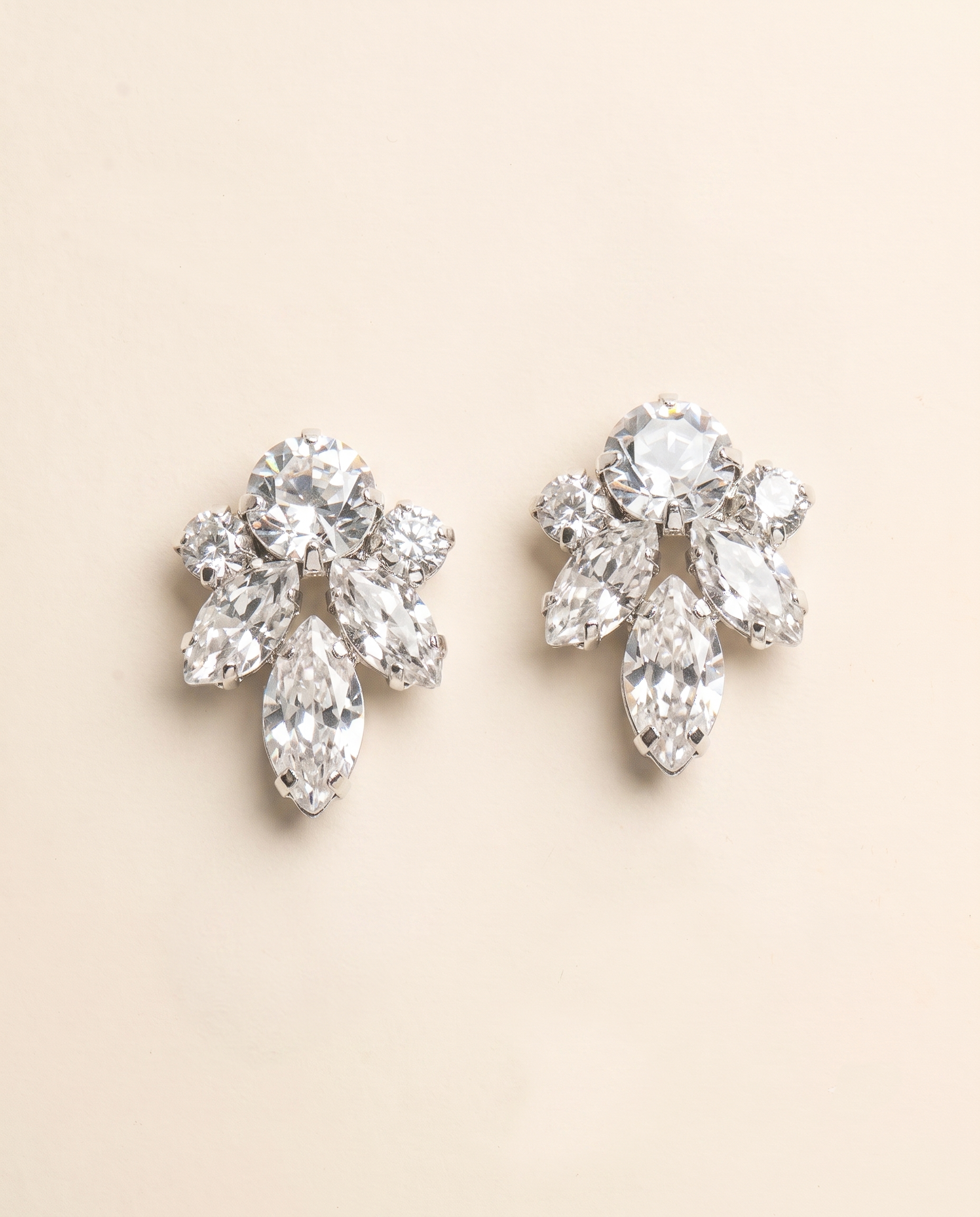 A pair of elegant diamond earrings with multiple large, clear gemstones set in a floral design.