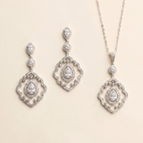 a set of elegant jewelry pieces, including earrings and a necklace, both adorned with sparkling diamonds.