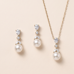 A set of elegant jewelry pieces, including a necklace and earrings, featuring a combination of pearls and diamonds.