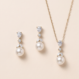 A set of elegant jewelry pieces, including a necklace and earrings, featuring a combination of pearls and diamonds.
