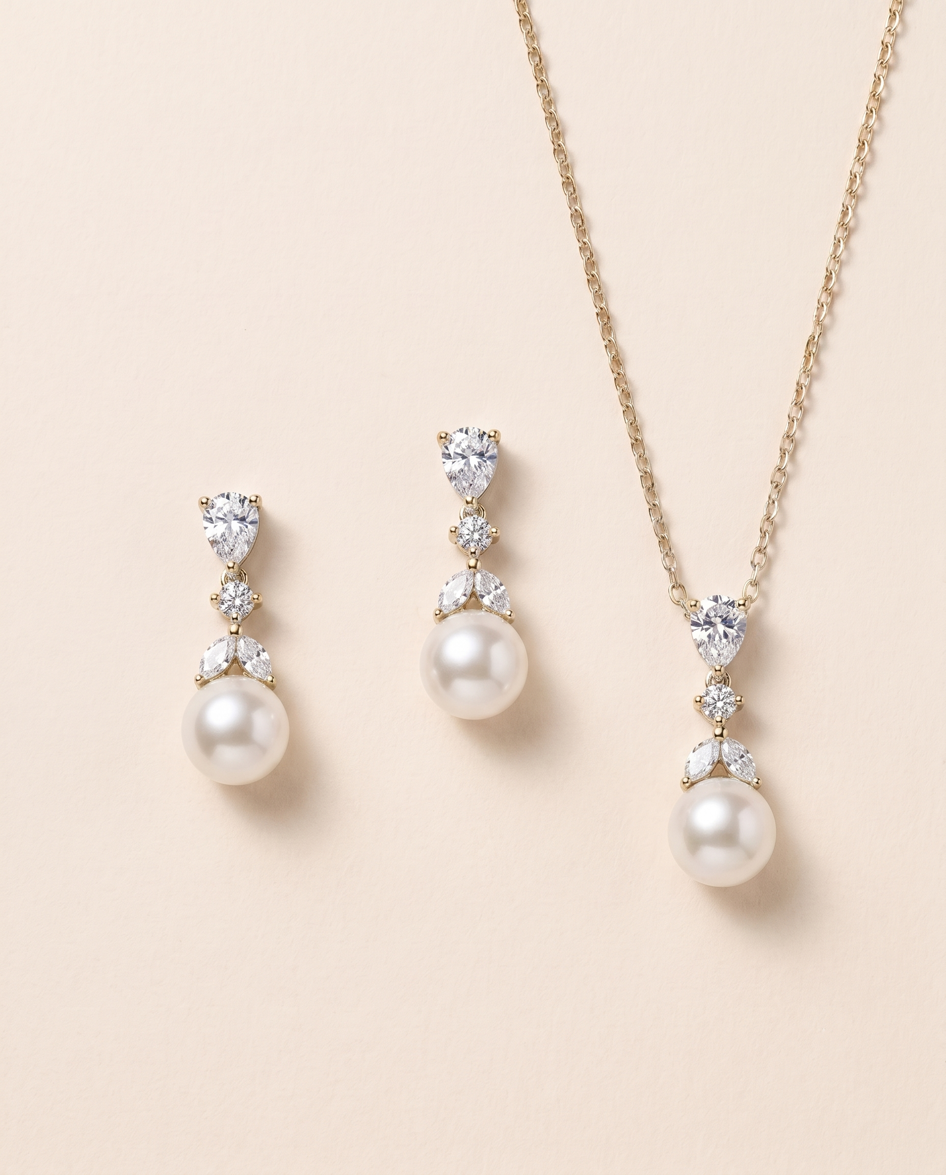 A set of elegant jewelry pieces, including a necklace and earrings, featuring a combination of pearls and diamonds.