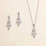 a necklace and earrings set against a light beige background.