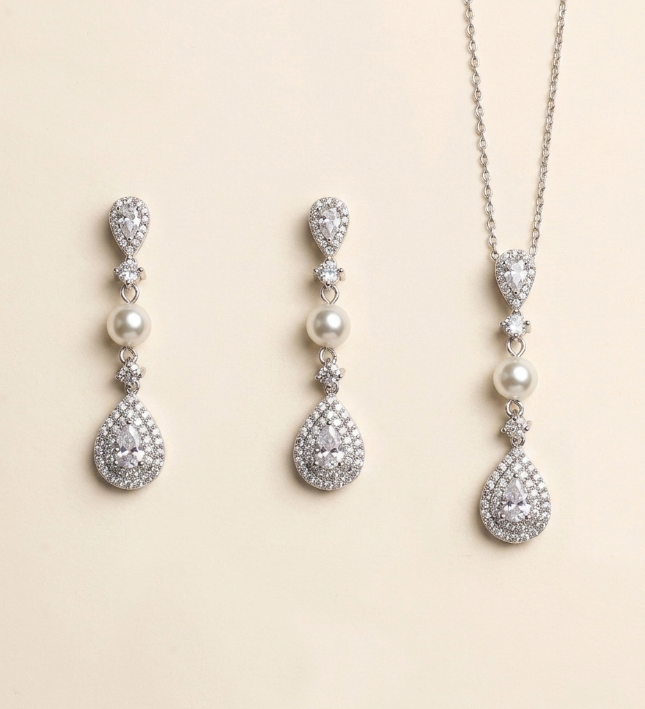 A set of elegant jewelry pieces, including earrings and a necklace, featuring a combination of pearls, diamonds, and gemstones.