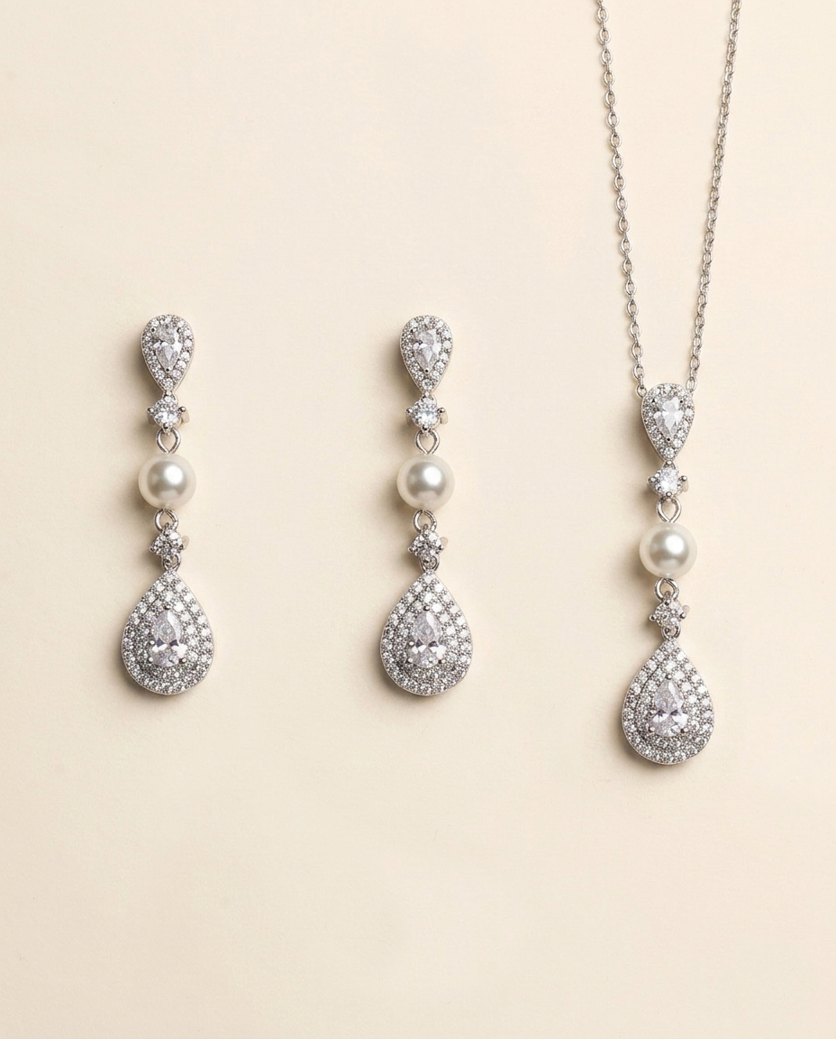 A set of elegant jewelry pieces, including earrings and a necklace, featuring a combination of pearls, diamonds, and gemstones.