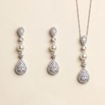 A set of elegant jewelry pieces, including earrings and a necklace, featuring a combination of pearls, diamonds, and gemstones.