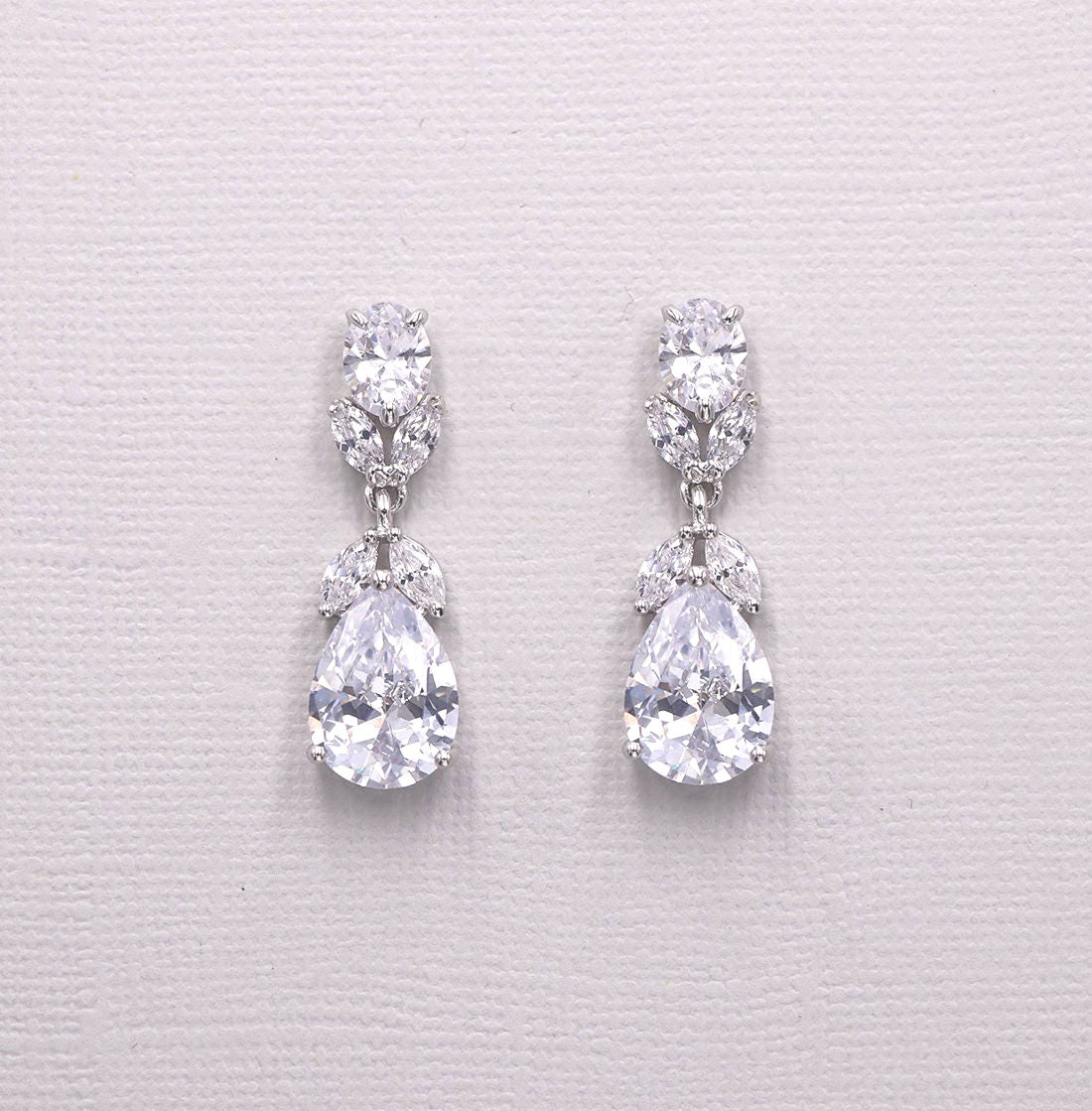A pair of elegant diamond earrings with large, clear gemstones set in a delicate, dangling design.