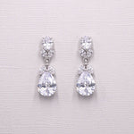 A pair of elegant diamond earrings with large, clear gemstones set in a delicate, dangling design.
