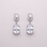 A pair of elegant diamond earrings with large, clear gemstones set in a delicate, dangling design.