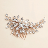 A decorative hair accessory with a floral design and numerous clear gemstones.