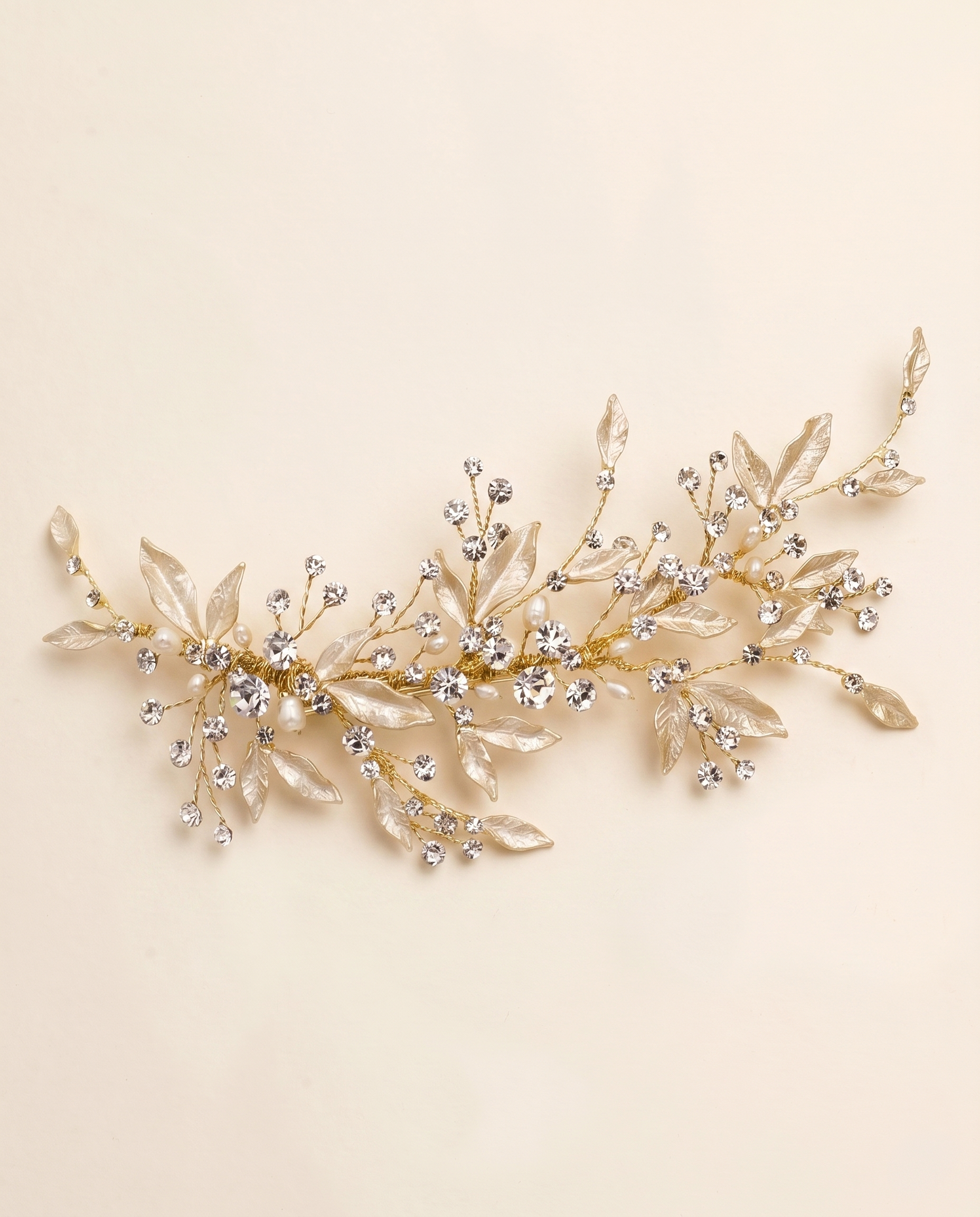 A decorative piece of jewelry with a branch-like design, adorned with small, clear gemstones or crystals.