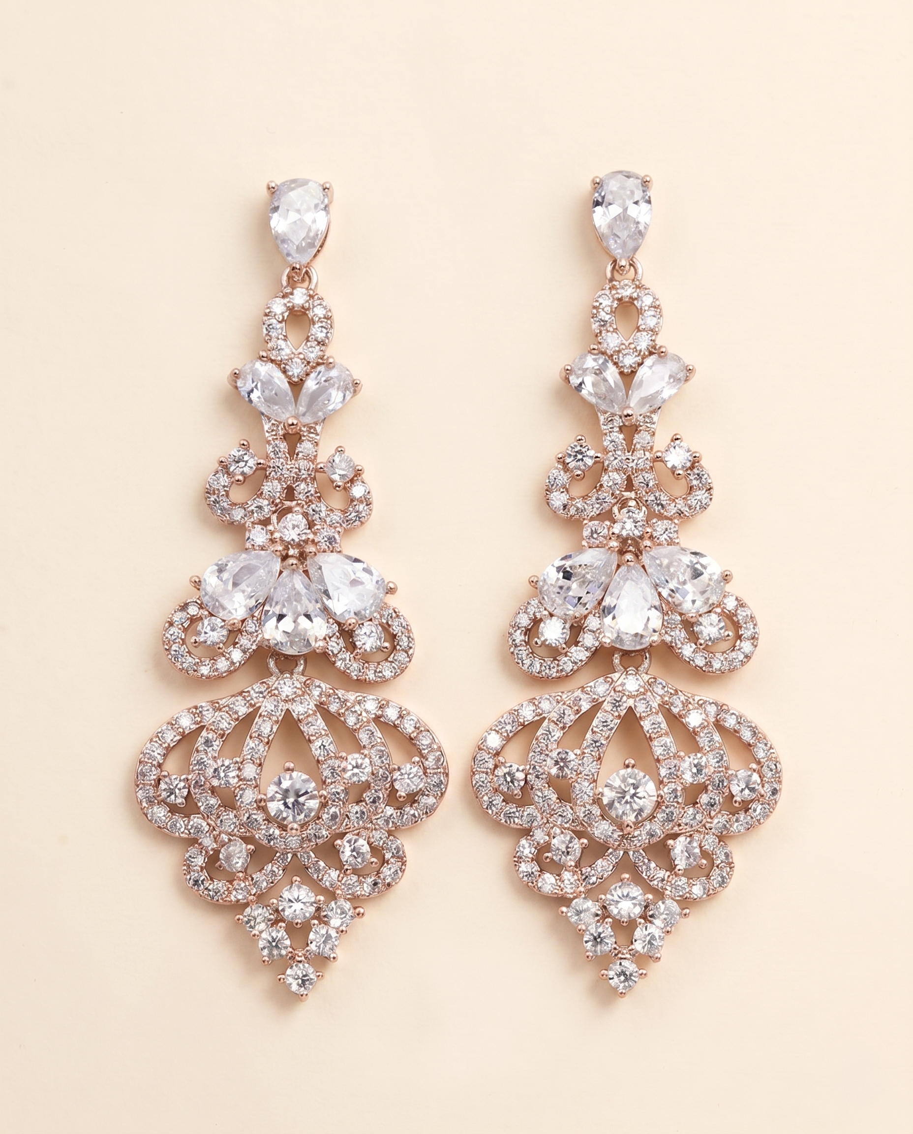 A pair of elegant gold earrings adorned with numerous sparkling diamonds.