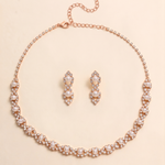 A necklace and earrings set made of gold and adorned with pearls and diamonds.