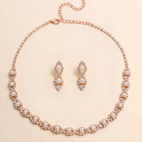 A necklace and earrings set made of gold and adorned with pearls and diamonds.