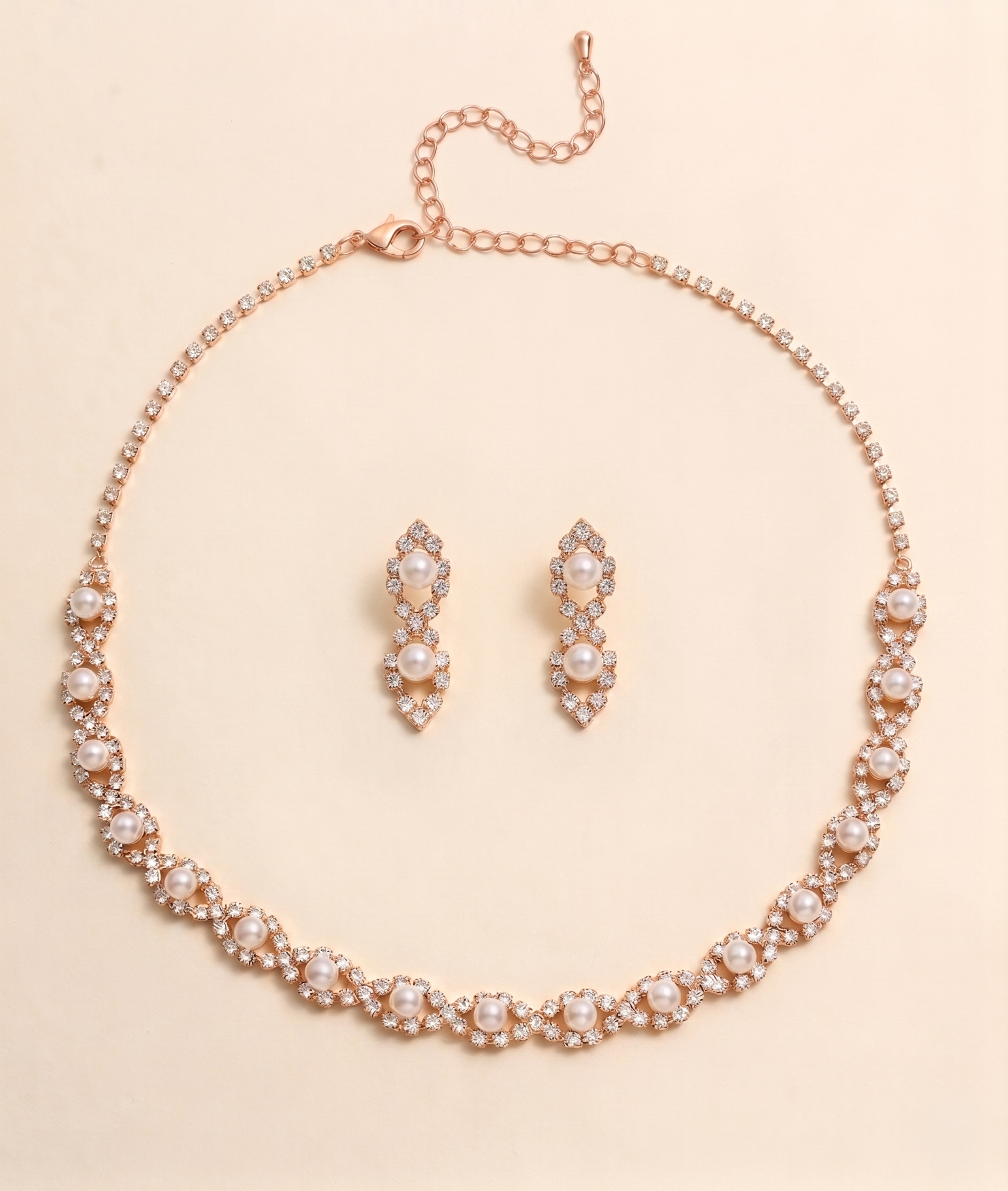 A necklace and earrings set made of gold and adorned with pearls and diamonds.