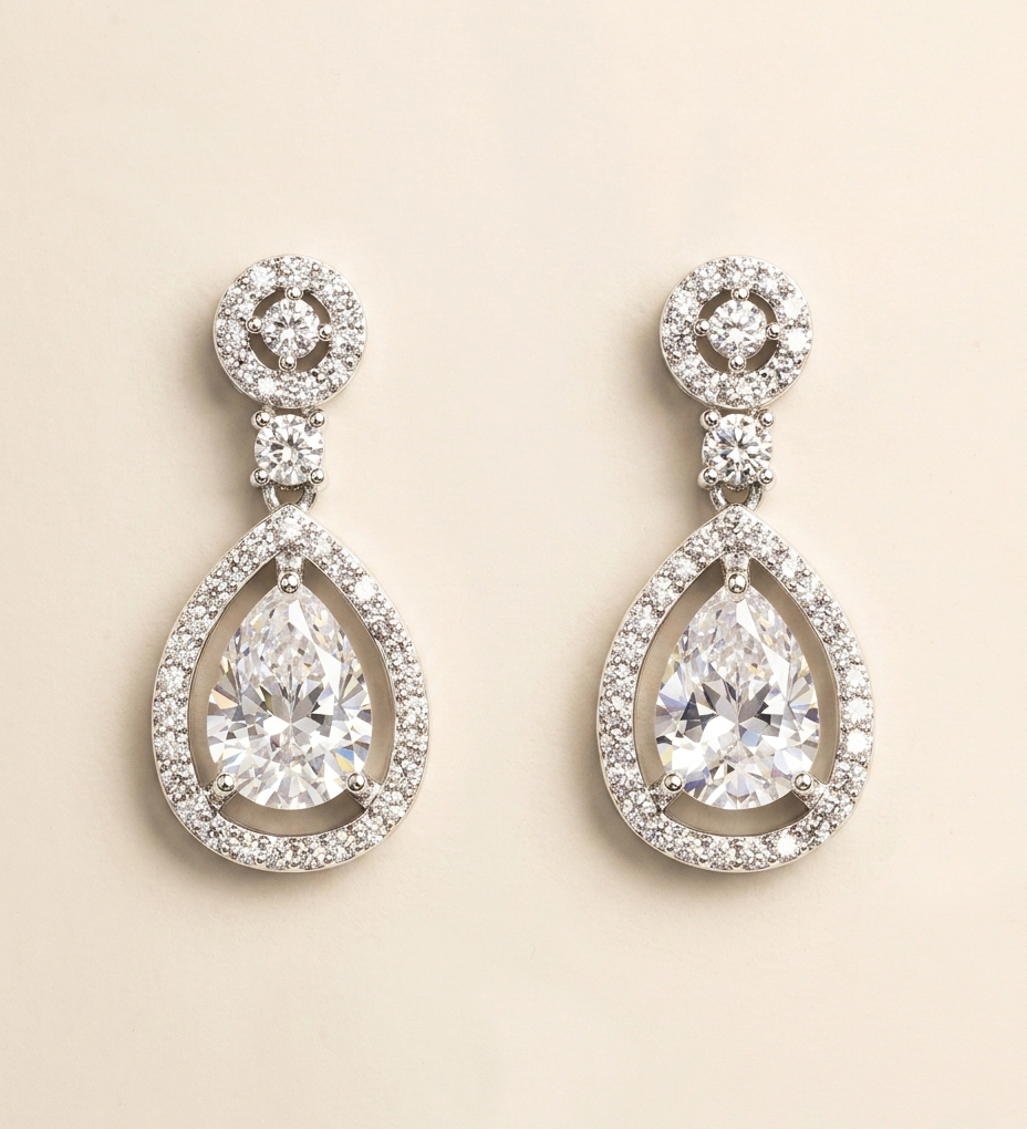 A pair of elegant diamond earrings with large, clear gemstones set in a sparkling, oval-shaped design.