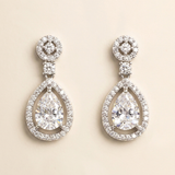 A pair of elegant diamond earrings with large, clear gemstones set in a sparkling, oval-shaped design.