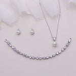 a necklace, earrings, and bracelet on a white background