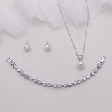 a necklace, earrings, and bracelet on a white background