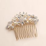 A decorative gold hair accessory with a floral design and sparkling crystal elements.