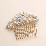 A decorative gold hair accessory with a floral design and sparkling crystal elements.