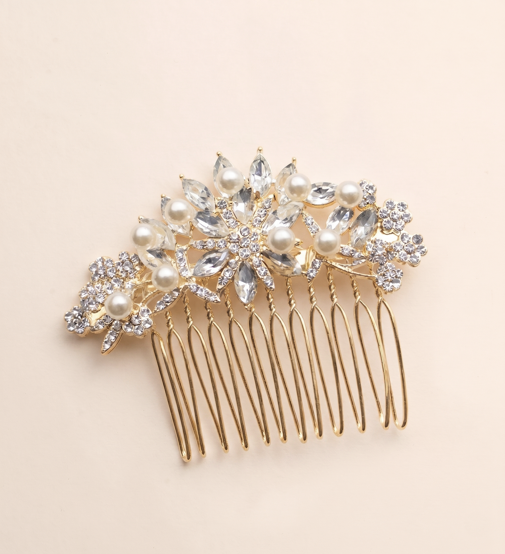 A decorative gold hair accessory with a floral design and sparkling crystal elements.