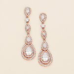 a pair of diamond earrings on a white background